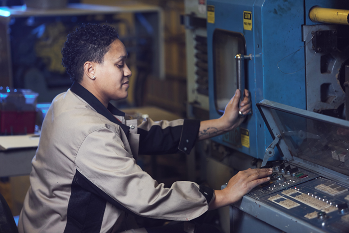 A machine operator working with industrial equipment.