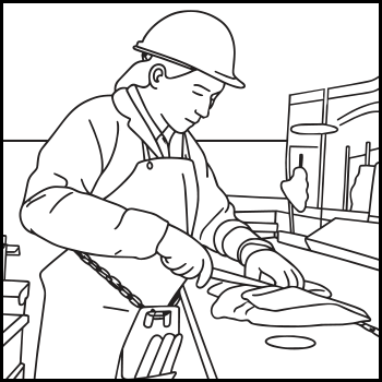A person wearing a helmet and apron, using a tool to work on a flat surface. 