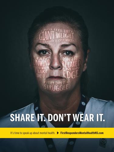 Mental-health awareness poster shows a distressed first responder with phrases such as “I just feel this giant weight,” “I don’t feel relaxed,” and “every day is a struggle” overlaid across face. Bold white slogan “SHARE IT, DON’T WEAR IT.