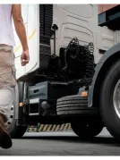 A person walking towards a parked truck.