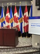 An image of government media room, showing flags of Canada and Nova Scotia.