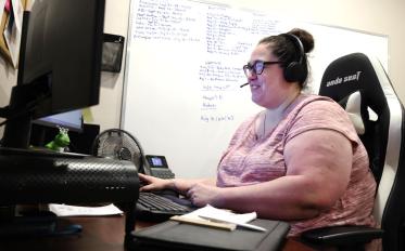 An employer shown sitting on a chair.