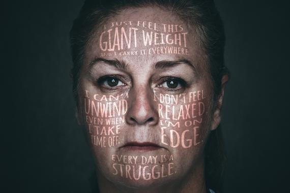 Mental-health awareness poster shows a distressed first responder with phrases such as “I just feel this giant weight,” “I don’t feel relaxed,” and “every day is a struggle” overlaid across face. Bold white slogan “SHARE IT, DON’T WEAR IT.