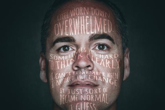 Mental-health awareness poster shows a weary male first responder with distressing thoughts projected across his face, including “I feel worn down,” “overwhelmed,” and “sometimes it’s hard to think clearly.” Bold white slogan “SHARE IT. DON’T WEAR IT.